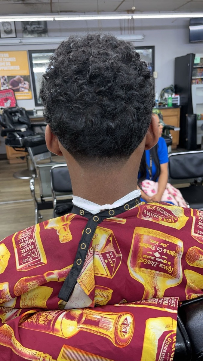 Curly top with a tapered blend at the back at Blend Addicts