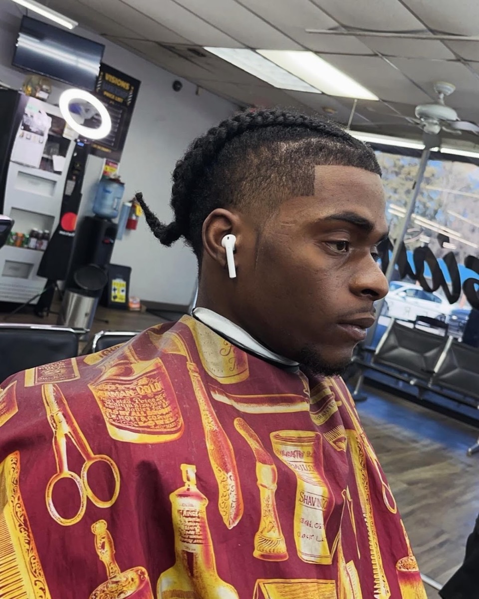 Braids with a crisp line-up and skin fade at Blend Addicts